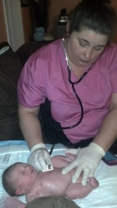Sarah Foster, Midwife, performs newborn exam.